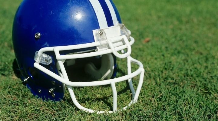 Close-up of a blue football helmet on the grass