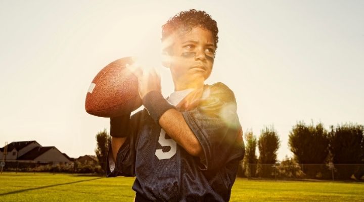 Youth football player about to throw the ball