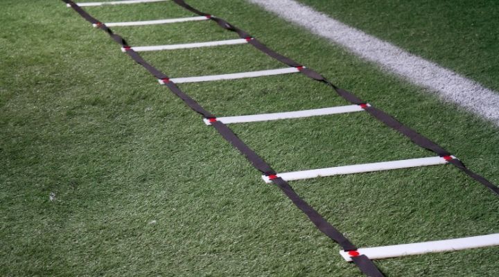 An agility ladder laid out on the grass