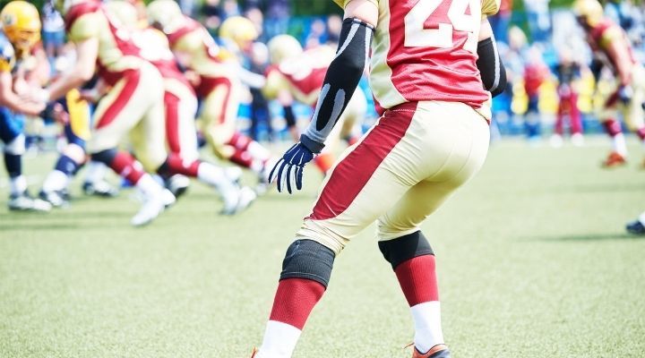A football player getting ready to catch the ball during a game