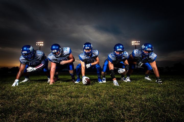 football players in blue jersey lined up on field
