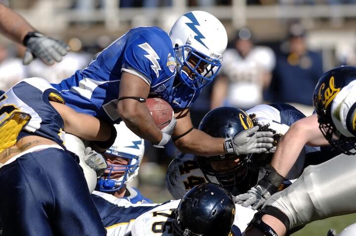 halfback-runs-with-the-football-through-defenders-during-a-football-game