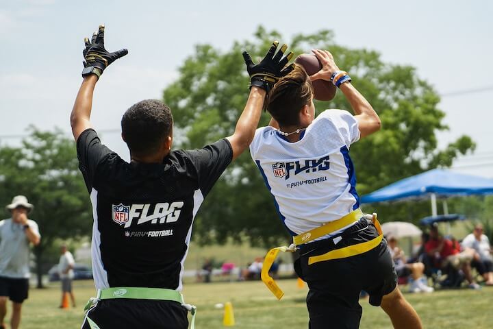 receiver makes a catch during a flag football match